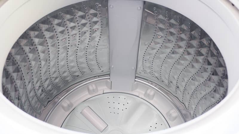 Top view of white washing machine without clothes loaded inside.