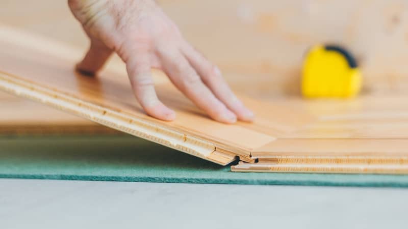 worker connecting floating floorboards