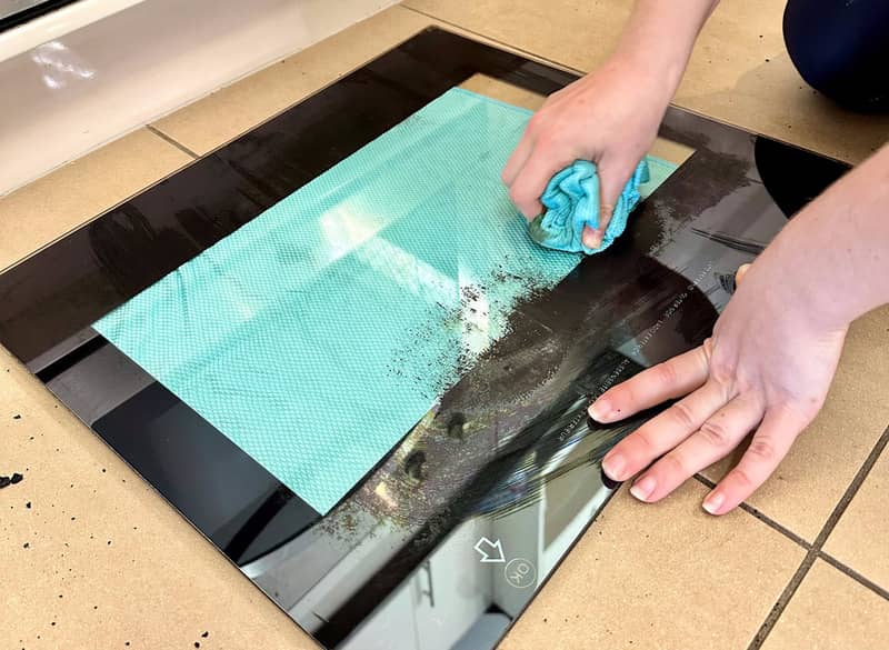 wiping debris off oven glass door