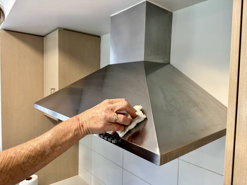 wiping the rangehood exterior